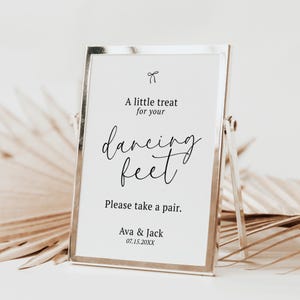 May include: A silver framed sign with the text "A little treat for your dancing feet. Please take a pair." The sign also includes the names "Ava & Jack" and the date "07.15.20XX".