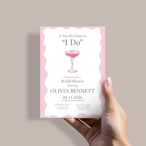 May include: A pink bridal shower invitation with a wavy border, held by a hand. The invitation features the text "A Tini Bit Closer to 'I Do'" and details for Olivia Bennett's shower, including the date, time, and location.