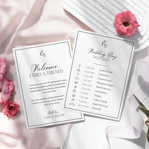 May include: Two white wedding day programs with black text. One program reads "Welcome, Family & Friends" and the other reads "Wedding Day 06.15.2025" with a detailed schedule. Pink flowers and ribbon are in the background.