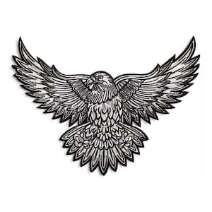 Könnte beinhalten: Ein gestickter Aufnäher in Schwarzweiß, der einen Adler mit ausgebreiteten Flügeln zeigt. Der Adler ist mit aufwendigen Nähten verziert und hat eine silberne Oberfläche.