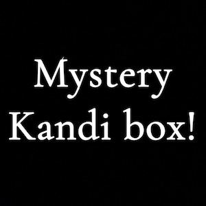 May include: A black background with the white text "Mystery Kandi box!" in a playful font. The text is centrally aligned and dominates the image.