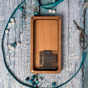 a wooden box with a string and a pair of scissors