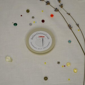 a white clock sitting on top of a table covered in confetti