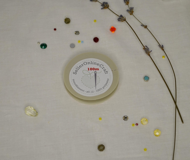 a white clock sitting on top of a table covered in confetti