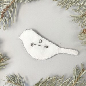 a white clock sitting on top of a tree