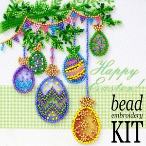 May include: A bead embroidery kit featuring a colorful Easter scene with hanging beaded eggs and a banner. The text "Happy Easter! bead embroidery KIT" is displayed on the white background.
