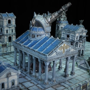 May include: A detailed miniature model of a futuristic city, featuring multiple buildings with classical architectural elements. The structures are primarily grey and blue, with intricate detailing and a large, mechanical telescope-like structure. The model is set on a tiled surface.