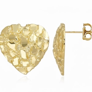 May include: A pair of gold-colored heart-shaped stud earrings. The earrings have a textured, nugget-like surface. The post of the earring is visible, with a small clasp. The earrings are set against a white background.