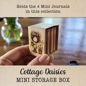 May include: A miniature storage box labeled "Cottage Daisies MINI STORAGE BOX" holds four mini journals. The box features an illustration of a girl watering flowers. The text "Holds the 4 Mini Journals in this collection" is also visible.