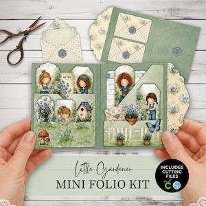 Può includere: Un kit mini folio Little Gardener con elementi in carta che presentano illustrazioni di bambini che fanno giardinaggio, fiori, funghi e una casetta per uccelli. Il kit include buste, etichette e tasche nei toni del verde, blu e crema, con il testo Little Gardener MINI FOLIO KIT e INCLUDES CUTTING FILES.