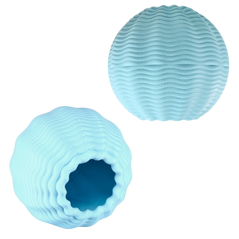 May include: Two light blue, spherical decorative objects. Each sphere has a textured surface with a wave-like pattern. One sphere has a large opening, revealing a darker blue interior. The objects are set against a white background.