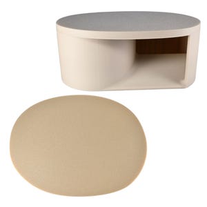 May include: A modern, minimalist coffee table in a cream color with a gray top. The table has a unique, open design with a curved base and a rounded, oval-shaped tabletop. An oval-shaped, beige-colored mat is in the foreground.