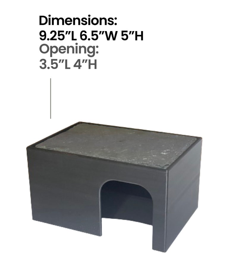May include: Black plastic reptile hide with a flat, gray, textured roof. Dimensions: 9.25"L 6.5"W 5"H. Opening: 3.5"L 4"H.