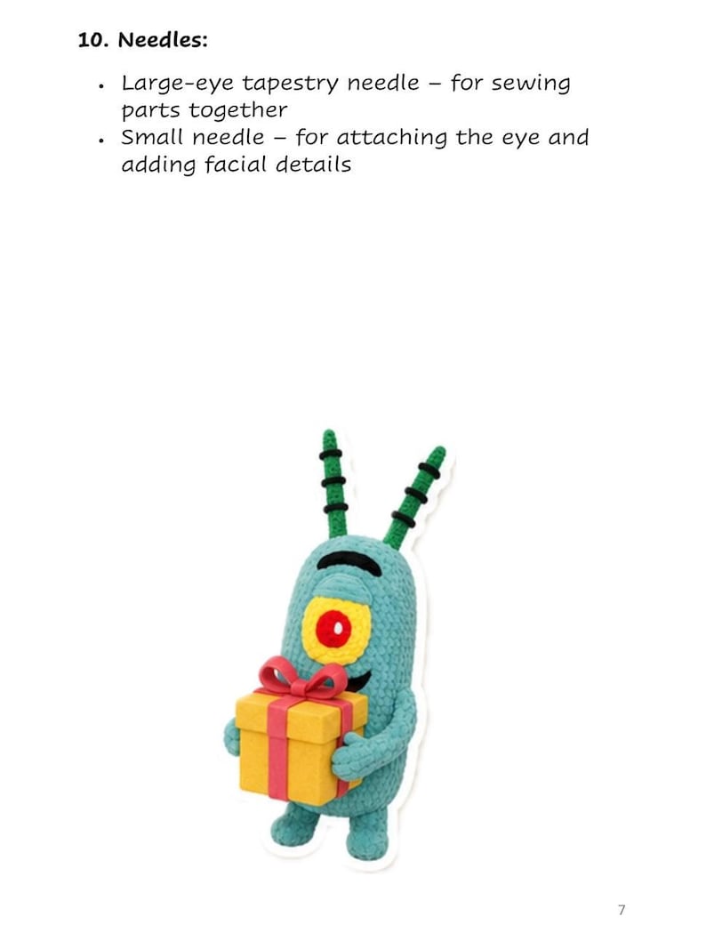 May include: A teal crocheted character with two antennae, a single large yellow and red eye, and small arms holding a yellow gift box with a red ribbon. Above the character, text reads: 10. Needles: Large-eye tapestry needle - for sewing parts together, Small needle - for attaching the eye and adding facial details.