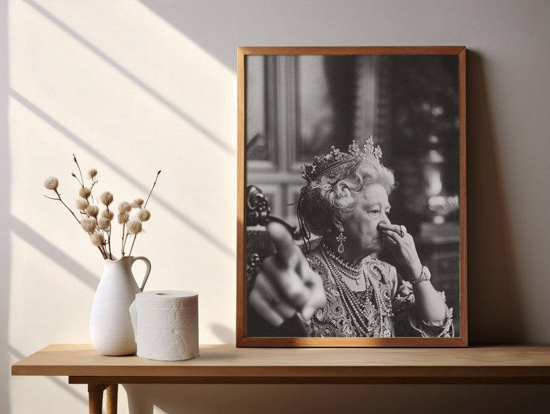 May include: A black and white photo of a woman wearing a crown and a pearl necklace. She is looking at the camera and has her hand raised in a gesture of pointing.