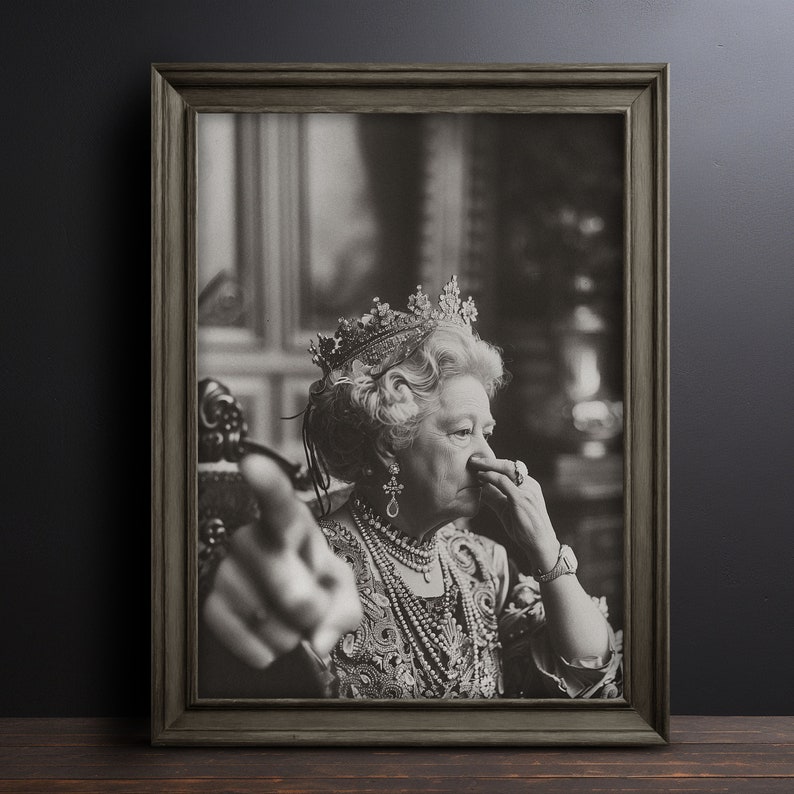 May include: A black and white portrait of a woman wearing a crown and a pearl necklace. She is looking at the camera and has her hand to her nose.