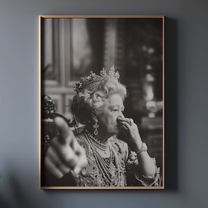 May include: Black and white portrait of a woman wearing a crown and a pearl necklace. She is looking to the side and has her hand near her face.
