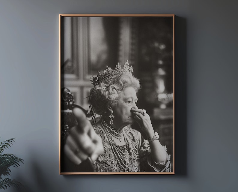 May include: Black and white portrait of a woman wearing a crown and a pearl necklace. She is looking to the side and has her hand near her face.