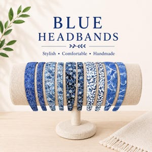May include: A display of blue headbands with floral patterns. The headbands are arranged on a beige stand. The text "BLUE HEADBANDS" is displayed above the headbands, with the words "Stylish, Comfortable, Handmade" below.