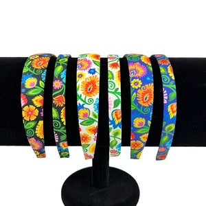 Headbands for women or girls covered  in bright florals-black, white, blue fabric.