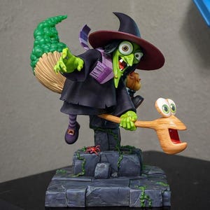 May include: A whimsical figurine of a green-skinned witch with a black hat and dress, riding a broom. The broom has a cartoonish face. The witch is perched on a stone base with a small red spider. A fun, fantasy-themed collectible.