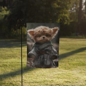 May include: A brown and white dog wearing a grey robe with a brown belt. The dog has large ears and is looking directly at the camera. The dog is in front of a green background.