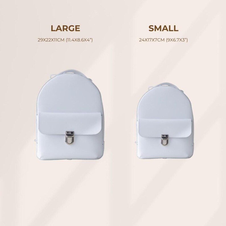 May include: Two white backpacks, one large and one small, are displayed. The large backpack measures 11.4 x 8.6 x 4 inches, while the small one is 9 x 6.7 x 3 inches. Each backpack has a flap closure with a silver-colored clasp.