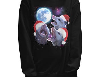 May include: Black sweatshirt with a graphic of three possums wearing Santa hats and singing in front of a full moon. The text "Gravity  Coaster" is visible on the bottom right of the graphic.