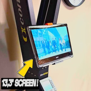 May include: A black SkiErg machine with a 13.3-inch Acer screen displaying a group of people. The screen is mounted on the machine. The machine has the word "concept2" in yellow on the side.
