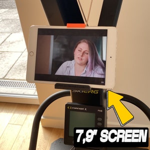 May include: A black and gray exercise machine with a 7.9" screen, a black and gray tablet holder, and a black and gray handle. The screen displays "Concept 2" and "PM5".