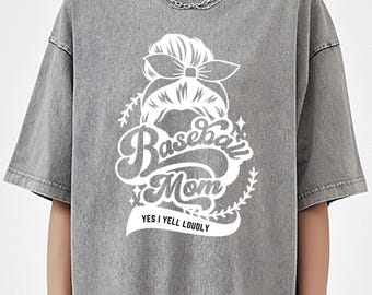 May include: Gray t-shirt with a white graphic of a woman's hair in a bun with a bow, the text "Baseball Mom" and the phrase "Yes I yell loudly".