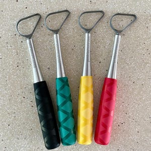 May include: Four metal sculpting tools with different colored handles. The handles are black, green, yellow, and red. Each tool has a loop at the top and the words "goodeclaytools.com" are printed on the side of each tool.