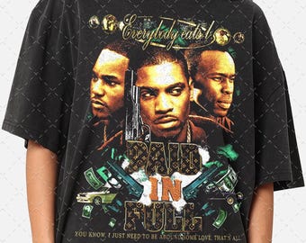 May include: Black t-shirt featuring a graphic design with three men's portraits, guns, and money. The text "PAID IN FULL" is prominently displayed, along with the phrase "Everybody eats". The shirt also includes the text "YOU KNOW, I JUST NEED TO BE AROUND SOME LOVE, THAT'S ALL."