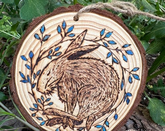 Art piece of a rabbit image on a hand-burned, pyrograved wood slice