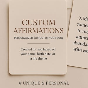 May include: Cards with text: "CUSTOM AFFIRMATIONS, PERSONALIZED WORDS FOR YOUR SOUL." The cards are beige with rounded corners. The text on the cards reads "Created for you based on your name, birth date, or a life theme."