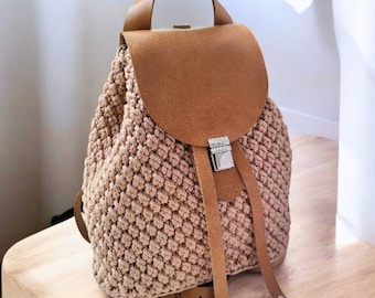 brown faux leather backpack with ivory floral crochet overlay Cara Riley House Crafts The Sayulita Crochet Backpack is hand Faux Leather Exterior Backpack Floral