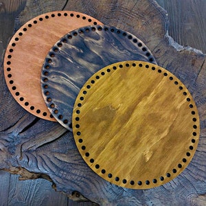 May include: Three round wooden bases with holes around the edge. The bases are in different shades of brown, including a dark brown, a light brown, and a reddish brown.
