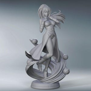 May include: A gray 3D printed figurine of a woman with long hair and a flowing dress. She is standing on a swirling base with several spheres.