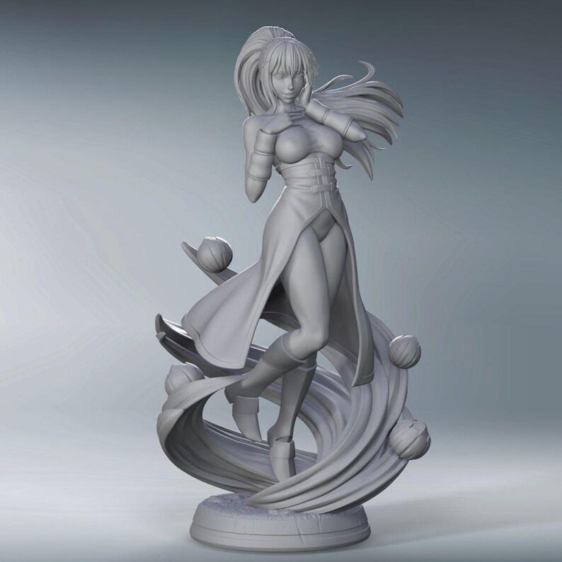 May include: A gray 3D printed figurine of a woman with long hair and a flowing dress. She is standing on a swirling base with several spheres.
