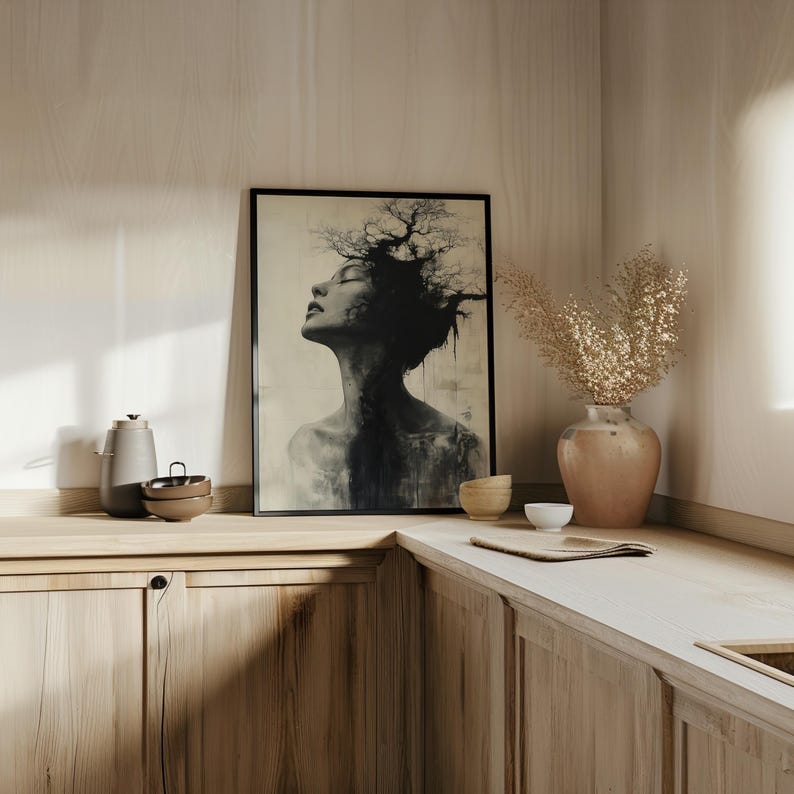 a picture of a woman's face on a wall above a kitchen counter