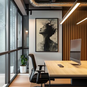 a picture of a woman's head hanging on a wall in an office