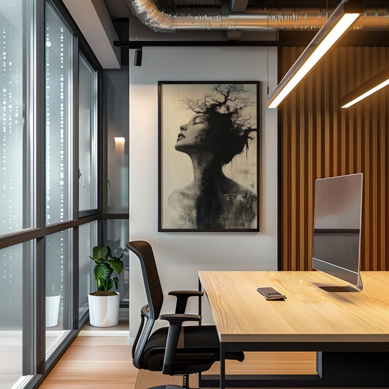 a picture of a woman's head hanging on a wall in an office