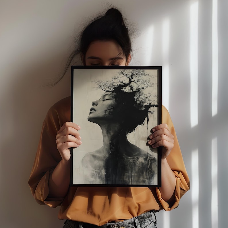 a woman holding up a picture of a tree