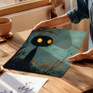 a person holding a piece of paper with a painting on it
