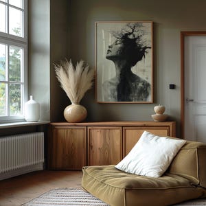 a living room with a couch and a painting on the wall