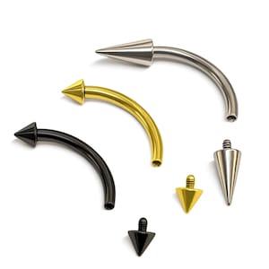 Könnte beinhalten: Eine Sammlung von gebogenen Augenbrauenringen und Ersatzspitzen in verschiedenen Farben. Der Schmuck umfasst silberne, goldene und schwarze Teile, alle mit einem spitz zulaufenden Kegeldesign. Die gebogenen Stäbe sind aus Metall.