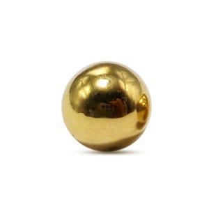 May include: A single, solid gold sphere, reflecting light with a polished, mirror-like surface. The ball is perfectly round and sits against a plain white background. The golden color suggests a precious metal.