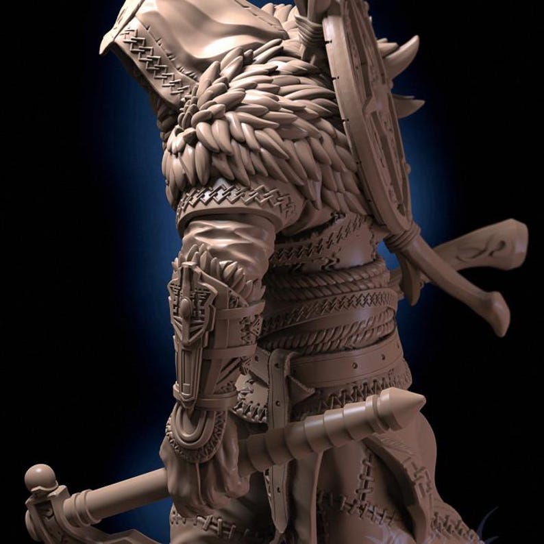 May include: A detailed figurine of a warrior wearing a hooded cloak with a feathered trim, holding a weapon and shield. The figurine is made of a light brown material and has intricate details.