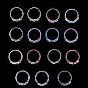 May include: Sixteen rings with status effect words in white lettering. The rings are in various colours, including yellow, green, purple, and blue. The words include "Stunned", "Poisoned", "Grappled", and "Unconscious".
