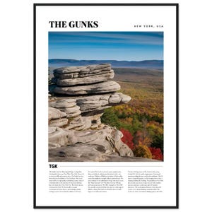 May include: A poster with a black frame and a white background. The poster features a photograph of a large rock formation with a blue sky and green trees in the background. The text "THE GUNKS" is at the top of the poster in large, bold, black letters. The text "NEW YORK, USA" is in smaller, black letters to the right of "THE GUNKS". The text "TGK" is in the bottom left corner of the poster. The text below "TGK" describes the rock formation and its location.